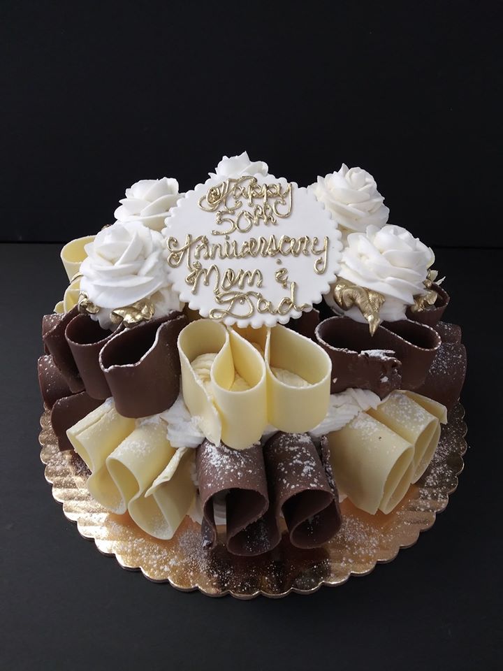 A cake decorated with chocolate and white swirls.