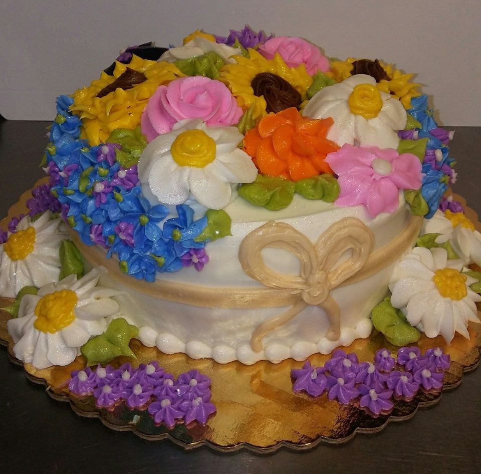 A cake decorated with flowers and bows.