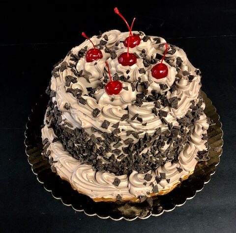 A chocolate cake with cherries on top.